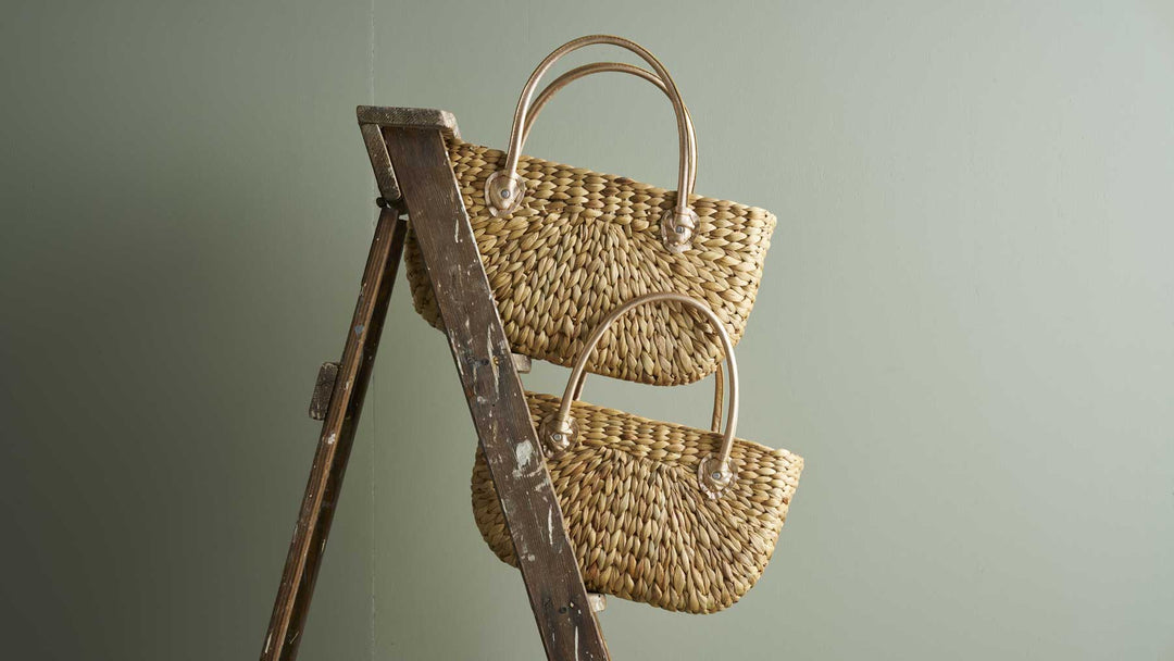 Robert Gordon's Harvest BAskets balance on a timber ladder against a soft olive green wall